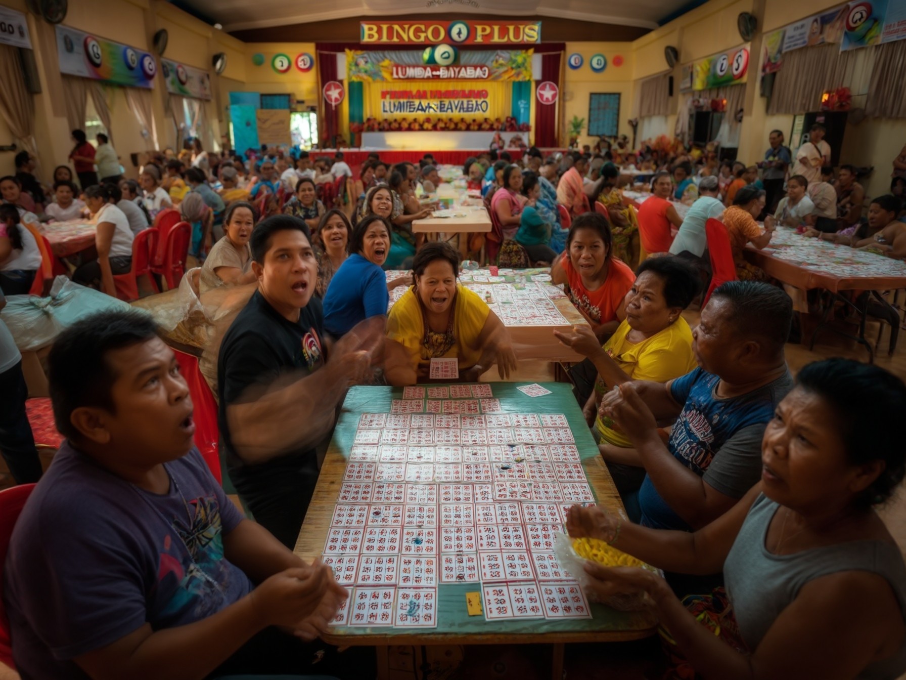 A crowded bingo hall with people sitting at tables playing bingo, featuring colorful bingo cards and a stage in the background.
